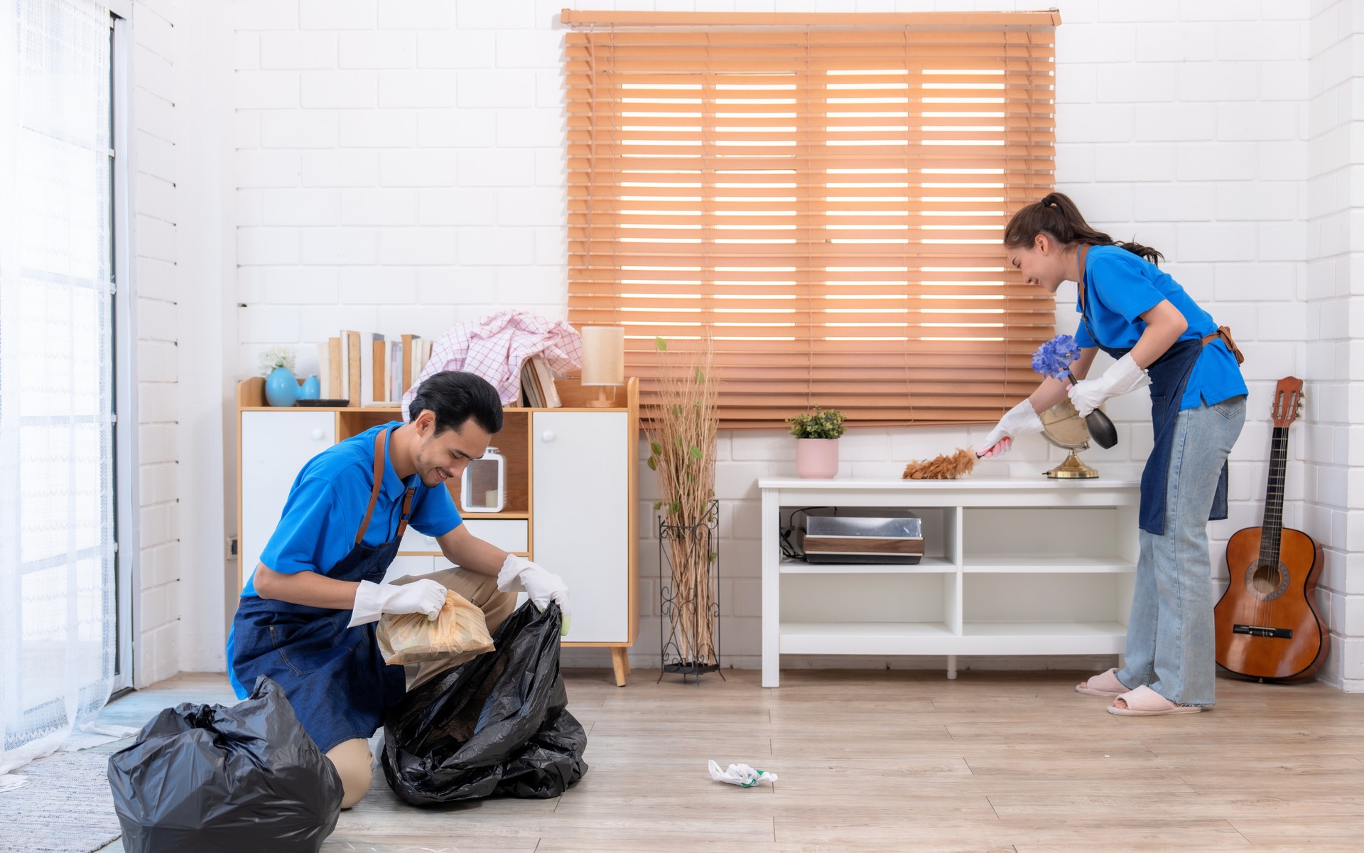 Male and female staff cleaning customers' homes.